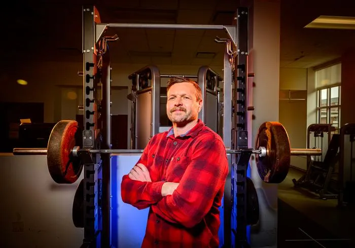Nicholas Burd stands in front of a weight rack