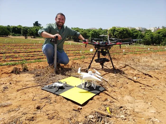 A small drone fleet near a young sesame experimental plot