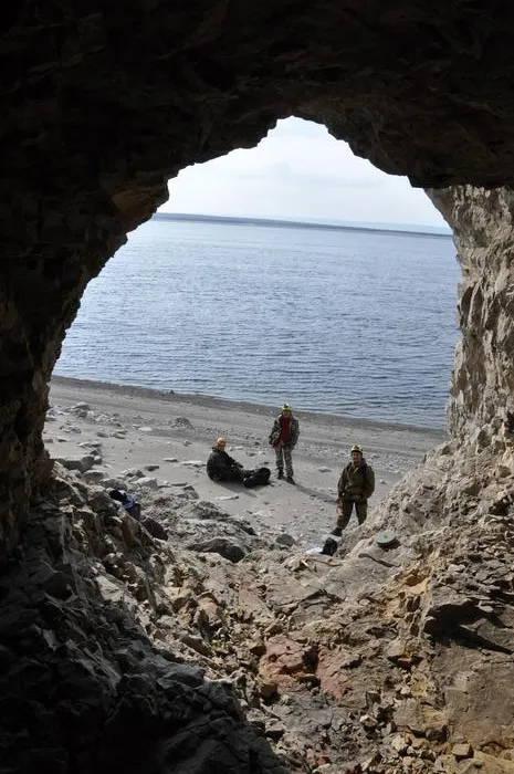 Team in cave at Arctic coast
