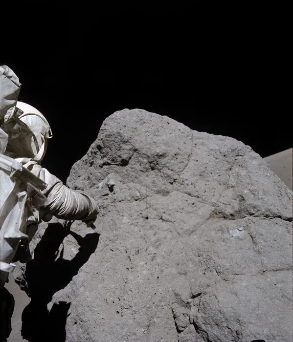Apollo 17 astronaut sampling boulder at Station 7