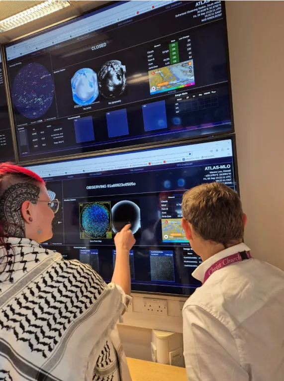 Dr Heloise Stevance and Professor Stephen Smartt with the Asteroid Terrestrial Impact Last Alert System (ATLAS), in the Astrophysics Data Lab, University of Oxford. Credit: Caroline W