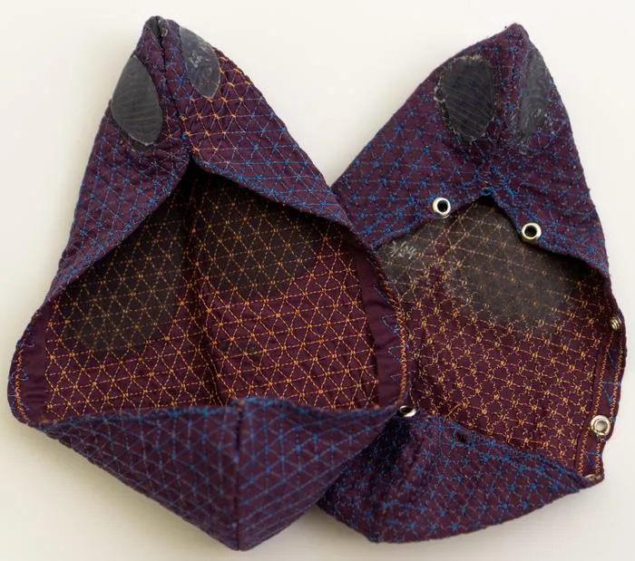 Pair of prototype footwear made from single embroidered textile pieces.
