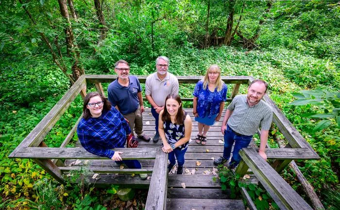 Research team stands on an observation deck overlooking a wetland