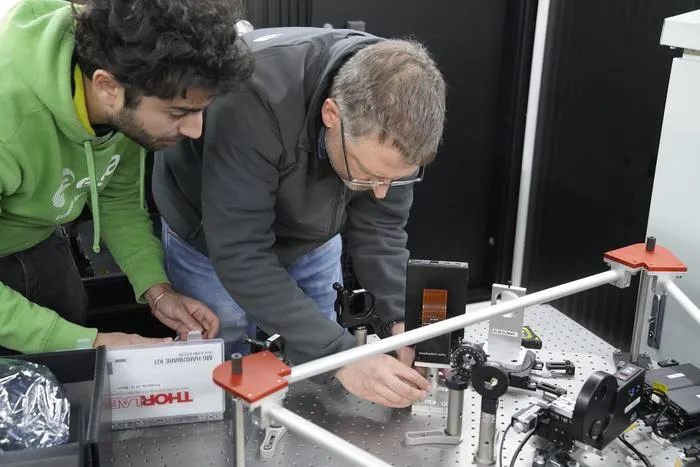 Ruben Tandon and Jonas Kuehn work on the PLACID instrument.