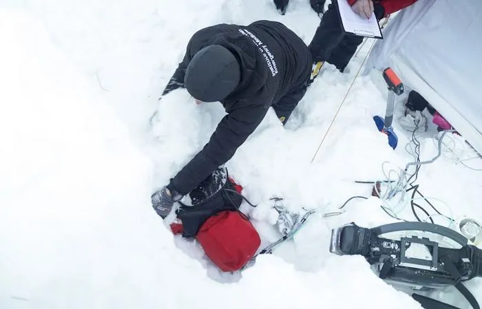 A participant is buried face down under about 50 centimeters of snow.ant is buried face down under about 50 centimeters of snow.