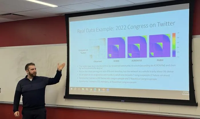 Benjamin Leinwand, assistant professor of mathematical sciences delivers a talk about his study findings