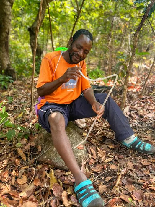 IMG_4399 – Fly trapper, Alick, sits by a river in Malawi