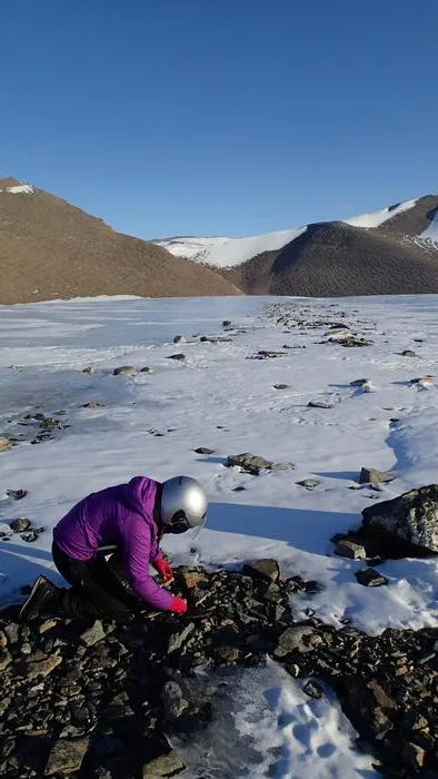 Photo 2: Dr Kate Winter collecting glacial sediments in Dronning Maud Land. Credit: Jacque Richon, IPF