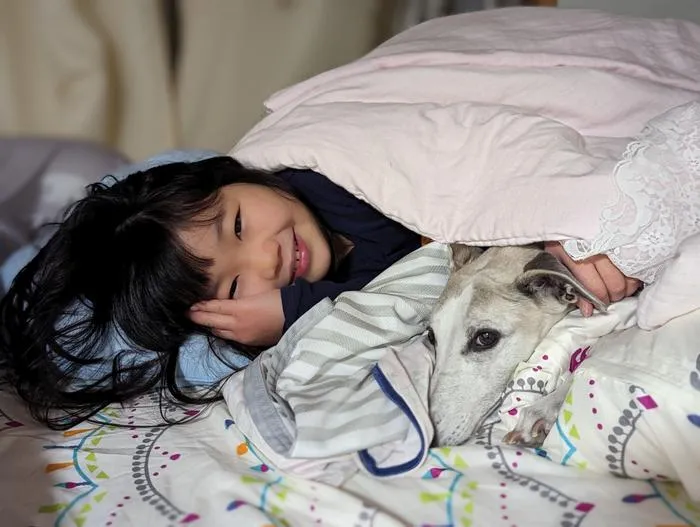 Girl cuddling with her dog