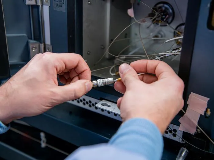 Researcher installs a new trapping column for liquid chromatography