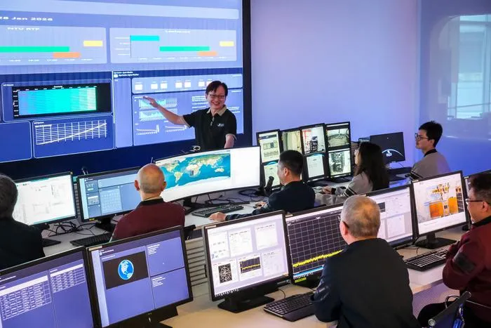 Satellite Research Centre Executive Director Mr Lim Wee Seng (top) briefing his team of scientists and engineers