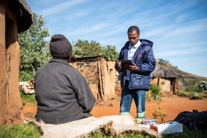 Lay health worker measures blood pressure