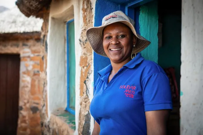 Lay health worker outside her home in Shapa-Ngoetsi
