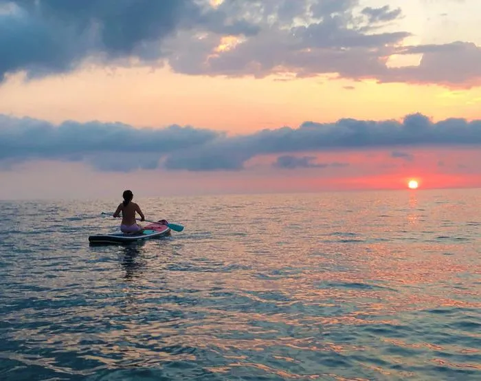 Gabriella Gobbi paddling on the Adriatic Sea at dawn.