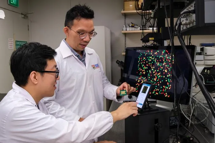 NTU Assoc Prof Y.C. Chen (right) in discussion with PhD student Fu Bowen