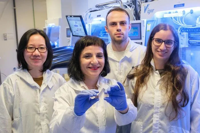Assoc Prof Annalisa Bruno, who is holding the ultrathin perovskite solar cell in her left hand, and her team