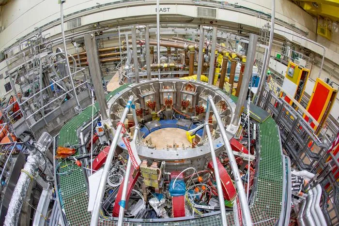 An overhead photo of NSTX-U shows a circular opening where the magnets at the center of the device will be placed.