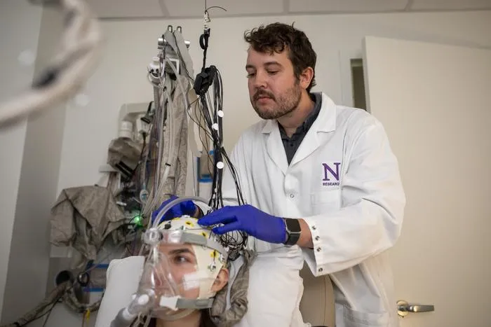 Study author adjusts participant's EEG cap