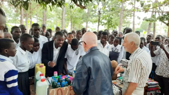 Team members talking to school pupils.