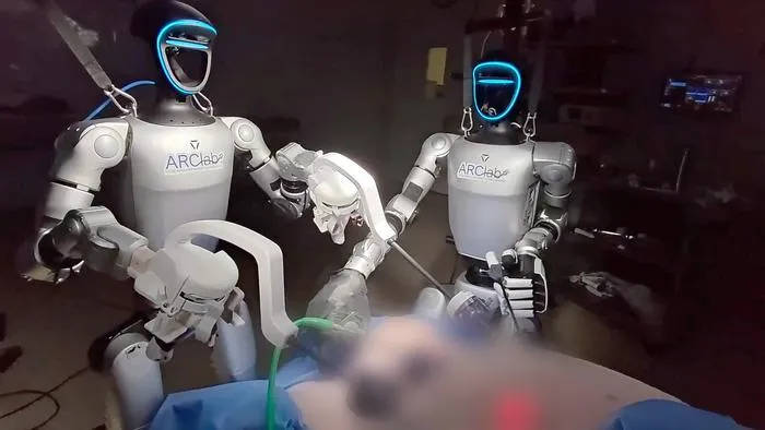 Two humanoid robots performing a laparoscopic surgery