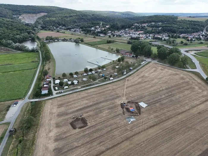 The two excavated areas, F1 and F2. In the background is the village of Burg with its swimming lake