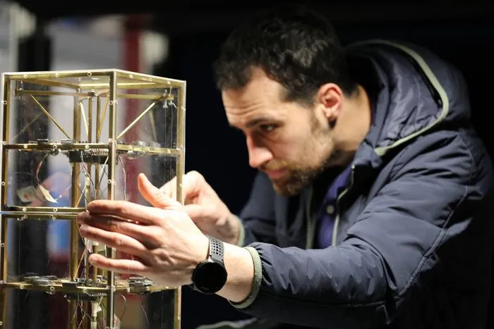 Miguel Martínez Pañeda performing small adjustments in the aeroelastic model between test runs