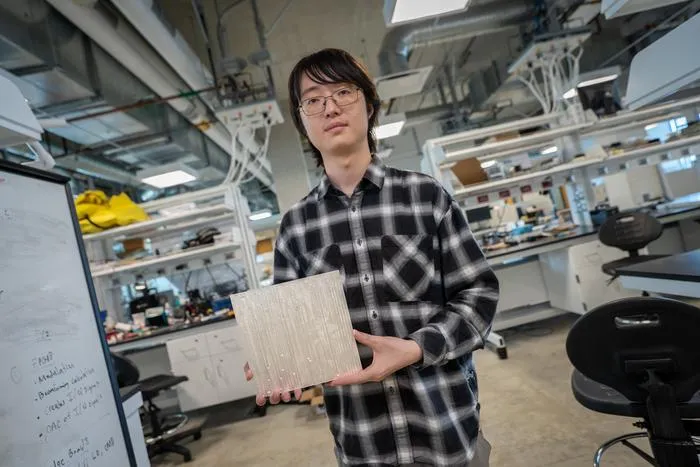 First author holding tile