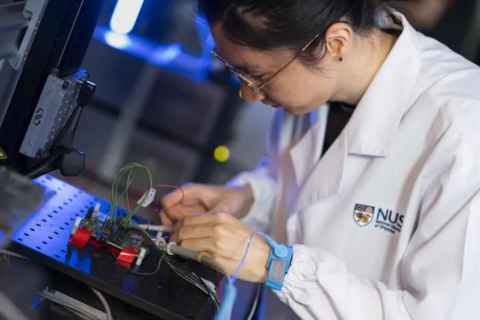 ST-NUS HELIX Lab - Researcher testing a silicon chip research prototype