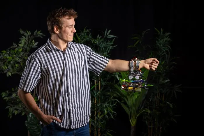 Gripper drone hanging onto researcher Anton Bredenbeck