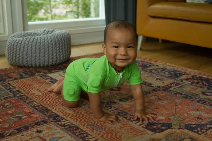 An infant wearing the MAIJU smart jumpsuit