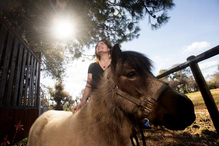Professor Rebecca Calisi Rodriguez with mini horse