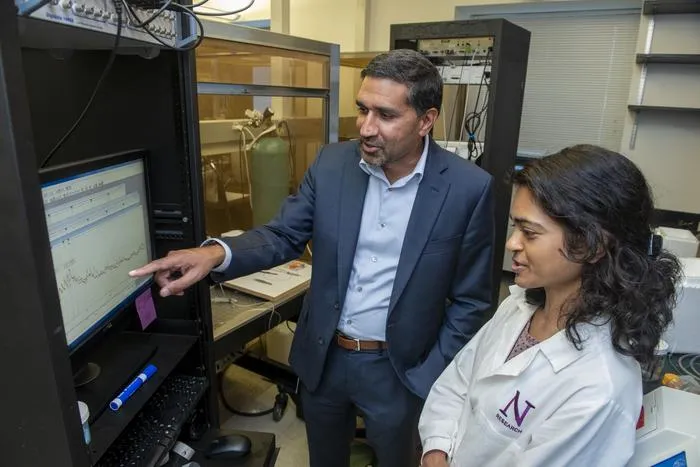 Study authors Drs. Sachin Patel (left) and Farhana Yasmin looking at brain recordings from central amygdala neurons