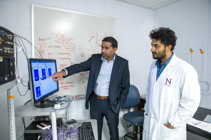 Study authors Drs. Sachin Patel and Saptarnab Naskar examine a heat map showing where the mice moved when exploring the threatening odor