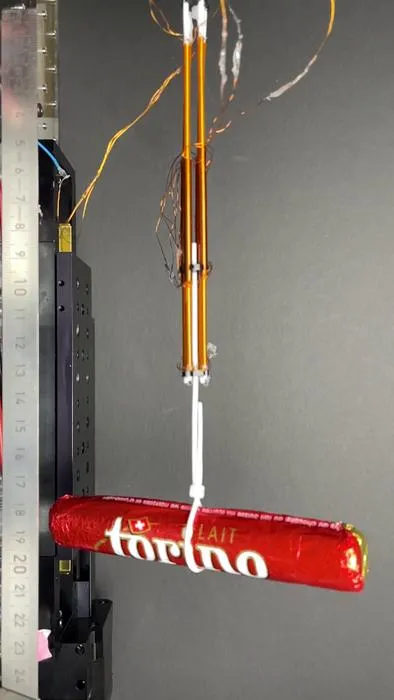 Bundled FiberMotors lifting a 46g chocolate bar
