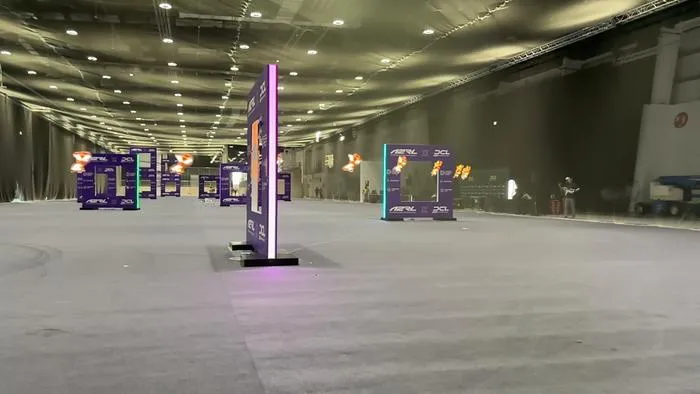 Timelapse photo of racing drone flying through final racing gate