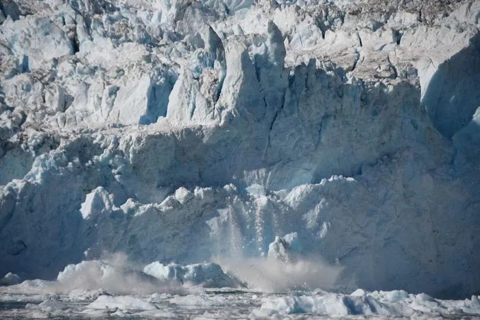 Rumleren Glacier calves ice from its face in South Skjoldungen Fjord, Greenland